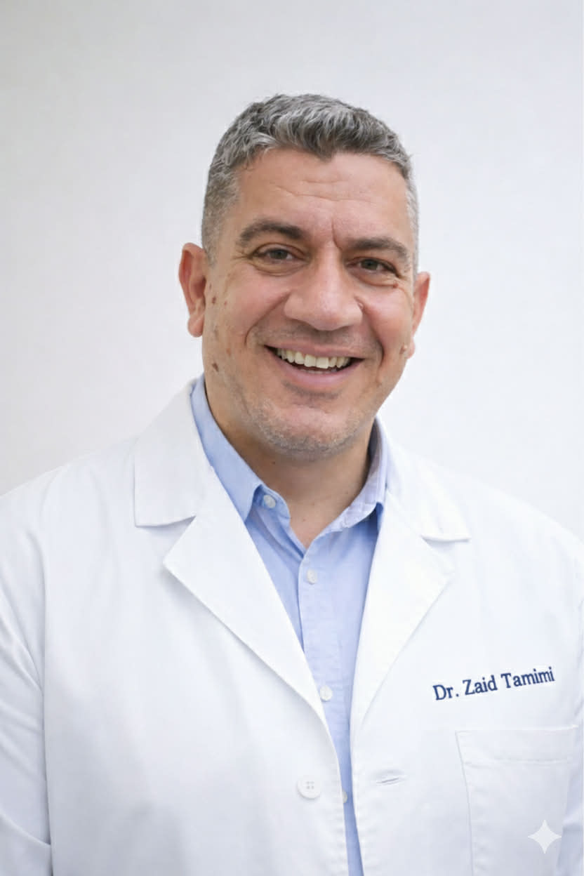 Dr. Zaid Tamimi, Consultant Oral and Maxillofacial Surgeon at Innovative Dental Center, smiling in a white clinical coat embroidered with his name